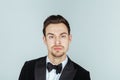 Young handsome man in a tuxedo, setiously looking at the camera Royalty Free Stock Photo